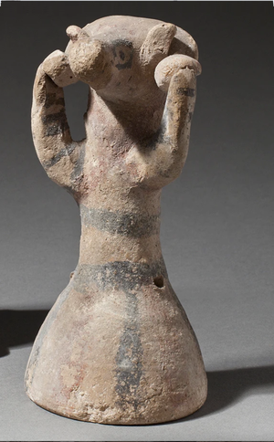 Priest wearing ram-head mask.