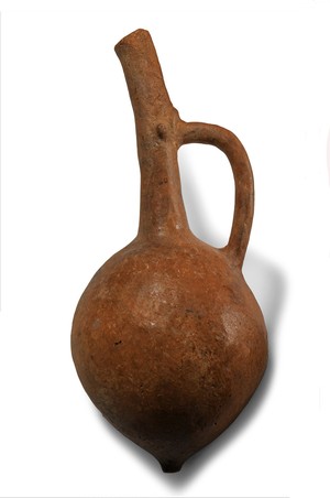 Jug with cut-away spout and nipple base.